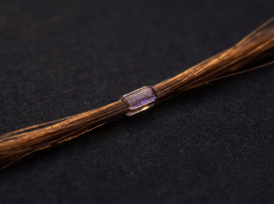 Macro shot of a transparent, discreet bond between two strands